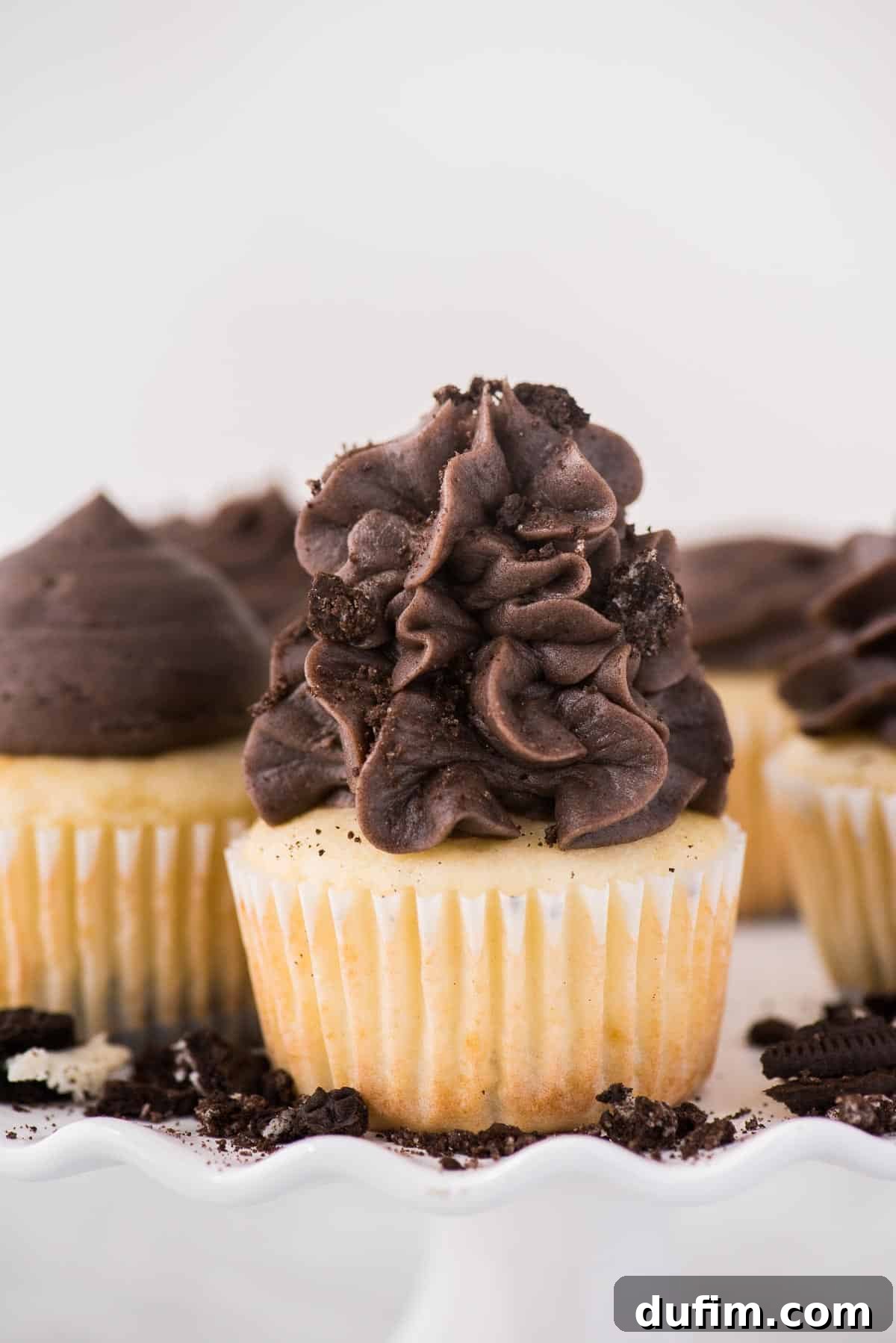 Oreo Cookie Crust Cupcakes 7 Vanilla Oreo bottom cupcakes presented beautifully on a white cake stand against a white background