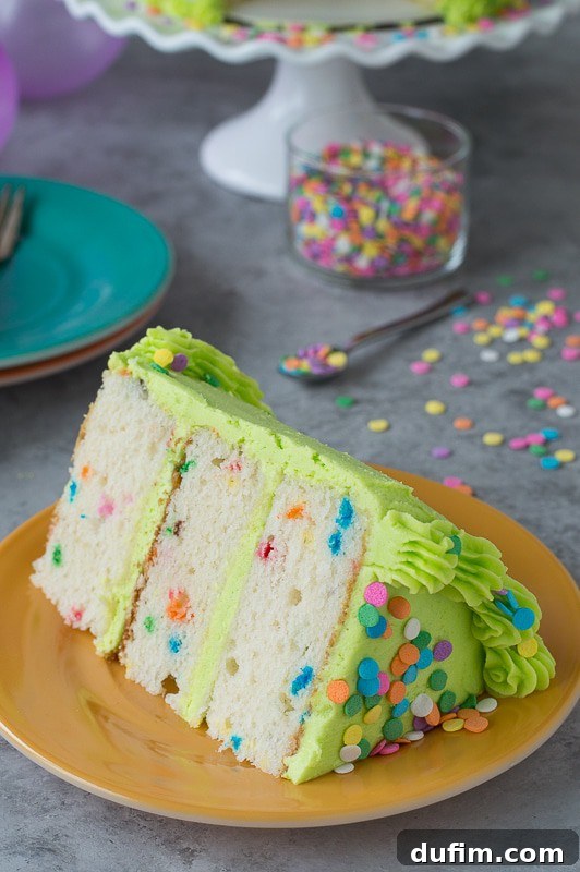 Homemade funfetti cake with lime green buttercream! A close-up, angled shot showcasing the texture of the buttercream and the colorful sprinkles used for decoration, inviting a taste.