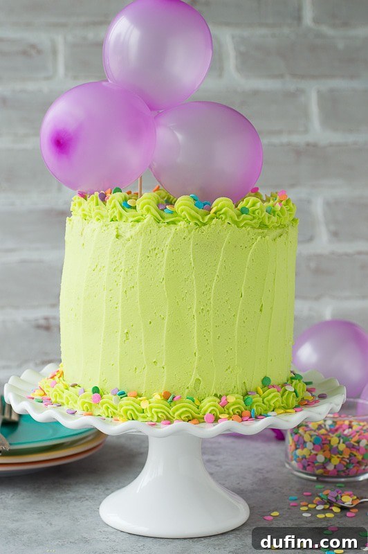 Homemade funfetti cake with lime green buttercream! Top the cake with a DIY balloon cake topper! Another vibrant close-up of the cake, emphasizing the sprinkles embedded in the cake batter and on the frosting, highlighting the funfetti magic.
