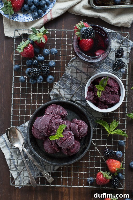 A single scoop of Berry Sangria Sorbet elegantly presented, highlighting its smooth texture and rich color.