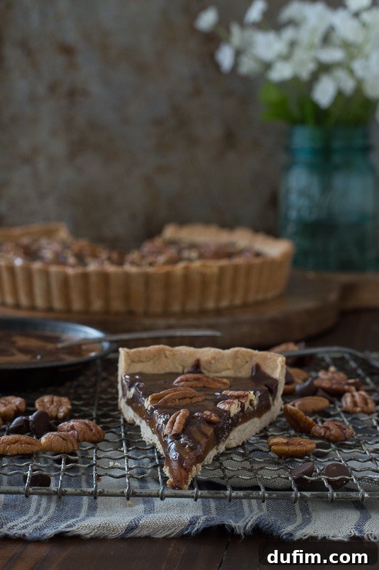 The final, glorious Turtle Tart, showcasing its artistic swirls of caramel and chocolate, adorned with toasted pecans and a glistening sprinkle of sea salt, ready to be sliced and served.