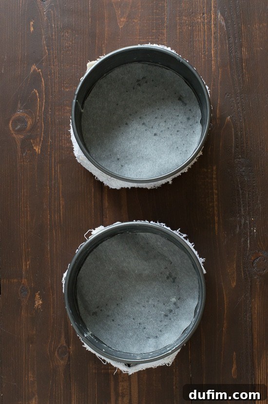 Preparing springform pans with butter, parchment, and bake even strips