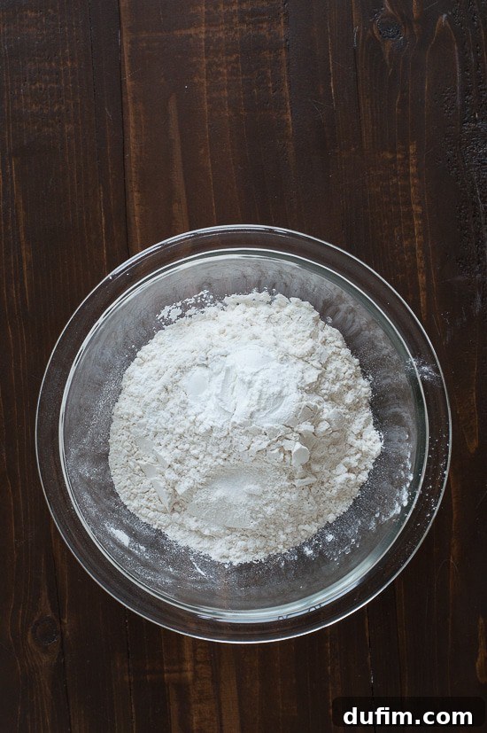 Combining dry ingredients for cake: flour, baking powder, salt