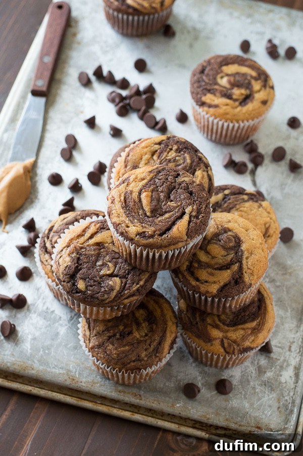 Chocolate Peanut Butter Bliss Cupcakes 3 Close-up of freshly baked swirled chocolate peanut butter cupcakes, showcasing the beautiful two-tone batter before frosting.