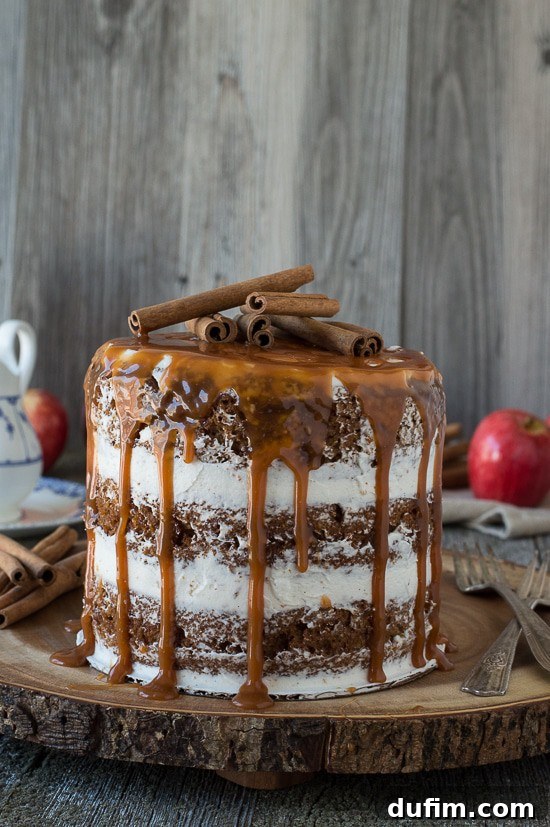 Harvest Apple Spice Cake with Golden Caramel Drizzle 2 A stunning three-layer naked apple spice cake with caramel drizzle flowing down its sides, garnished with cinnamon sticks and fresh apples. Perfect for fall celebrations.
