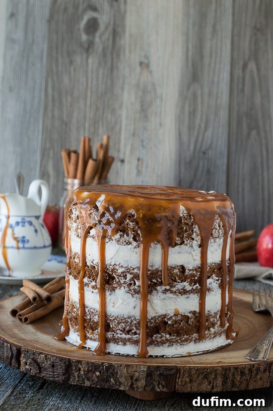 Harvest Apple Spice Cake with Golden Caramel Drizzle 3 Close-up of a slice of apple spice cake, revealing its moist texture and layers of vanilla bean buttercream, all crowned with a luscious caramel drizzle.