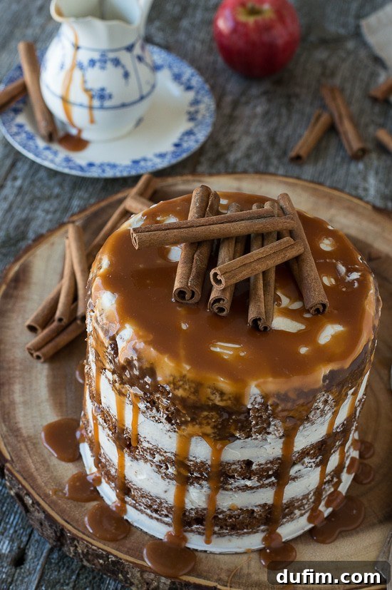 Harvest Apple Spice Cake with Golden Caramel Drizzle 4 A beautifully composed shot of the naked apple spice cake, with its rustic frosting and glistening caramel, embodying the warmth of autumn.