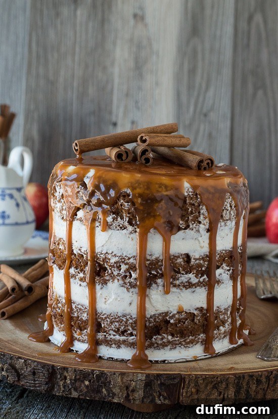 Harvest Apple Spice Cake with Golden Caramel Drizzle 6 A stunning side view of the Apple Spice Cake with caramel drizzle and cinnamon sticks, highlighting its layered texture and appealing presentation.