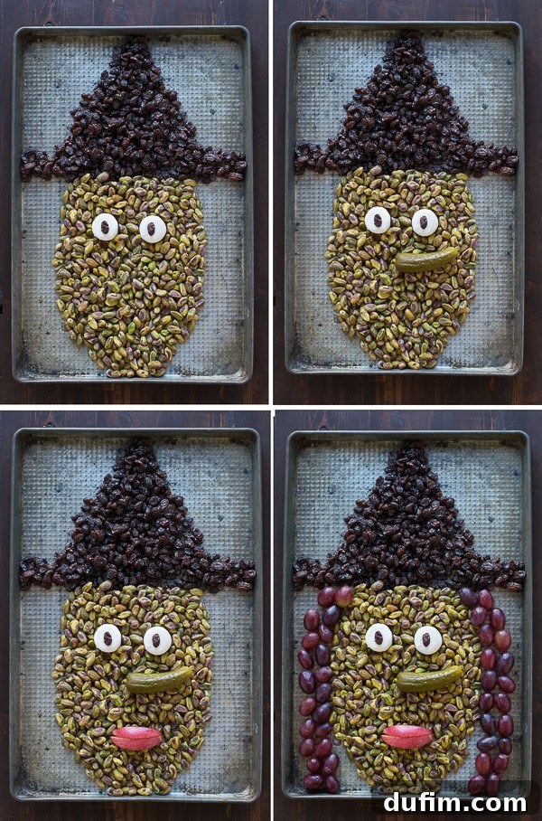 Progress shot of the Halloween Witch Platter, with the raisin hat complete and pistachios carefully arranged to form the witch's facial outline.