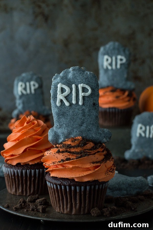 An overhead shot of Halloween Tombstone Cupcakes arranged on a plate, highlighting the delicious chocolate base and creative Rice Krispie treat decorations.