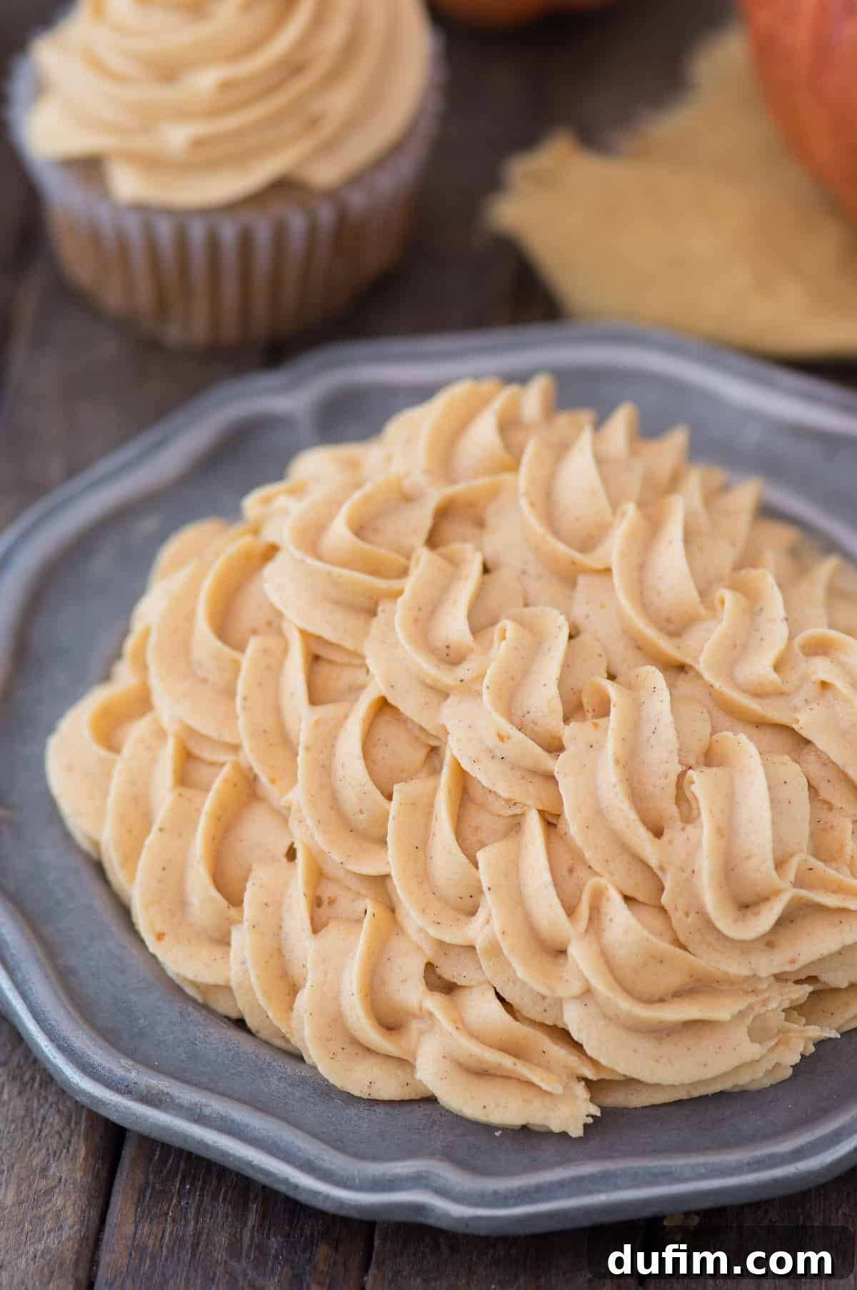 pumpkin buttercream frosting piped onto metal plate