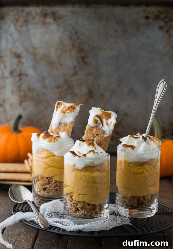 Spiced Pumpkin Cheesecake Parfaits 2 Pumpkin pie cheesecake shooters topped with toasted meringue, beautifully presented.