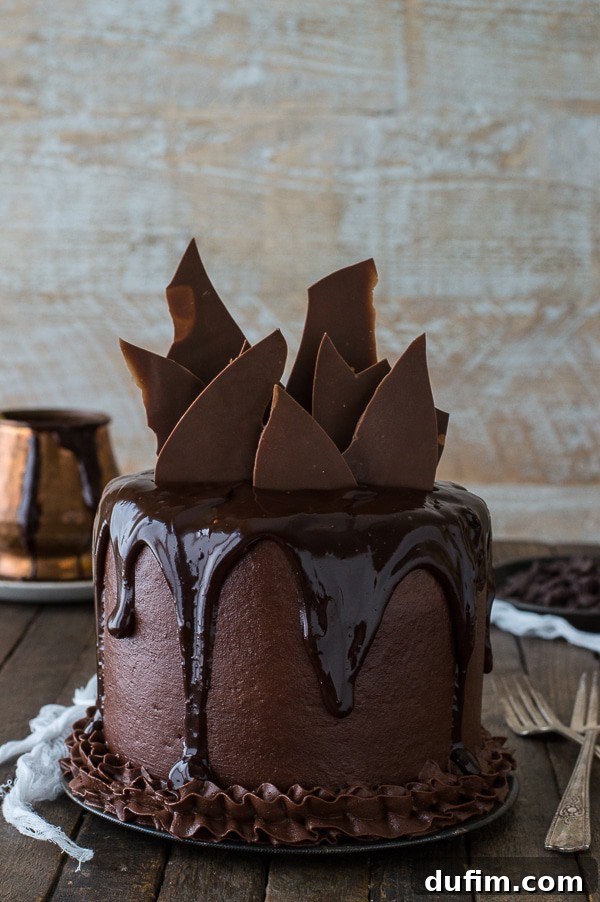 Homemade Chocolate Chocolate Cake with chocolate buttercream frosting on a serving dish.