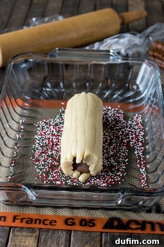 Gingerbread Spice Ready-Slice Cookies 12 Adding festive nonpareil sprinkles to the assembled gingerbread cookie dough log.