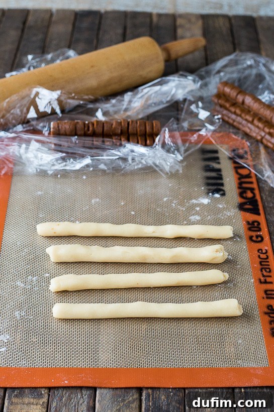 Gingerbread Spice Ready-Slice Cookies 9 Forming ropes with the outer cookie dough for Homemade Gingerbread Men Slice N’ Bake Cookies.