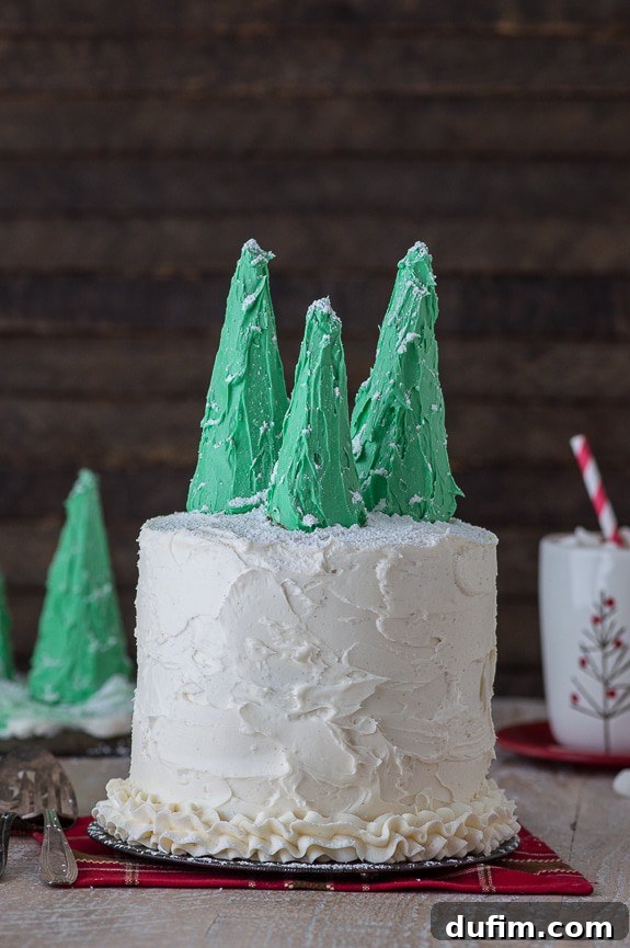 Delicious 3-layer gingerbread cake with vanilla bean buttercream and festive snowy christmas tree toppers
