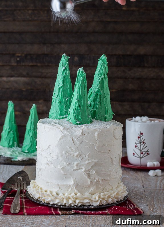 Close-up of a slice of gingerbread cake revealing its moist layers and creamy vanilla bean frosting