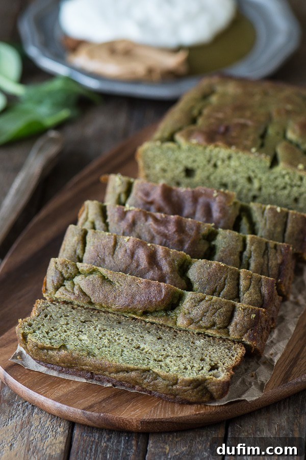 Deliciously moist slice of green monster bread, showing its vibrant green hue and texture, fresh from the oven.