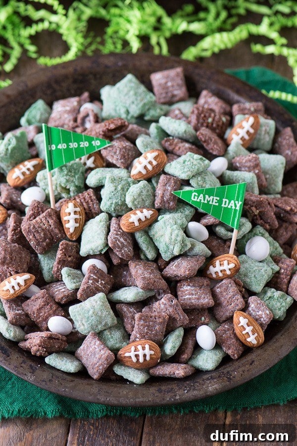 Delicious green and brown Football Puppy Chow with almond footballs and 'Game Day' flags in a metal serving dish