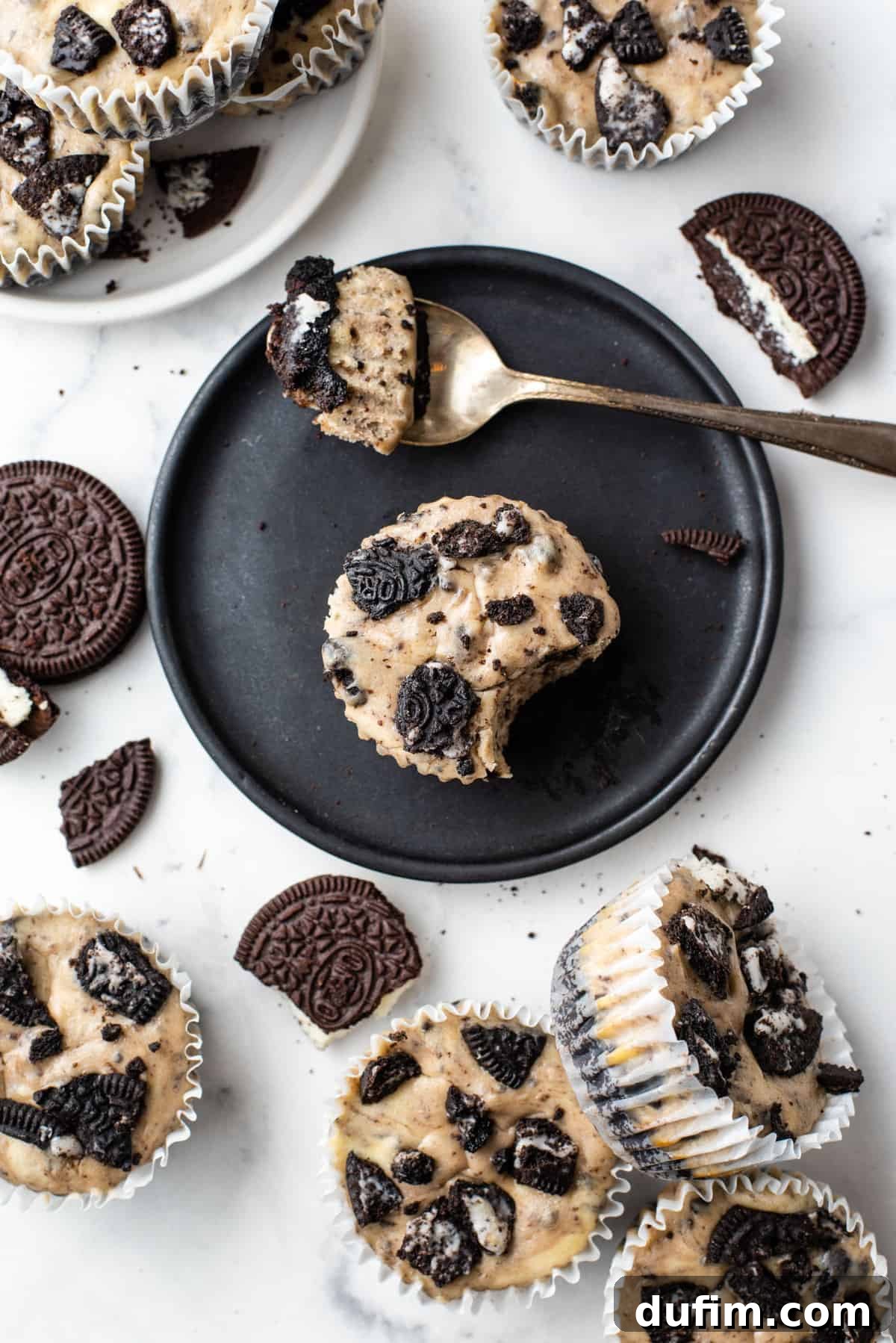 oreo cheesecake cupcakes arranged in plates on white background