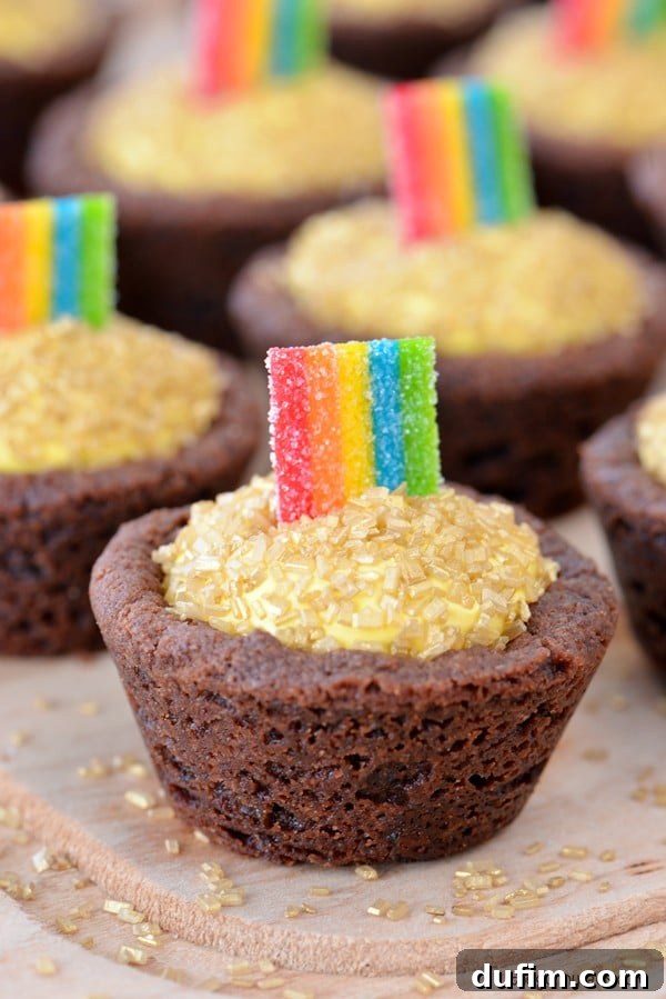 Delicious Pot of Gold Cookie Cups displayed on a rustic wooden board, ready for a St. Patrick's Day feast.