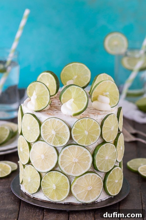 The process of decorating the coconut lime cake, showing layers of cake and buttercream, before the final lime embellishment.