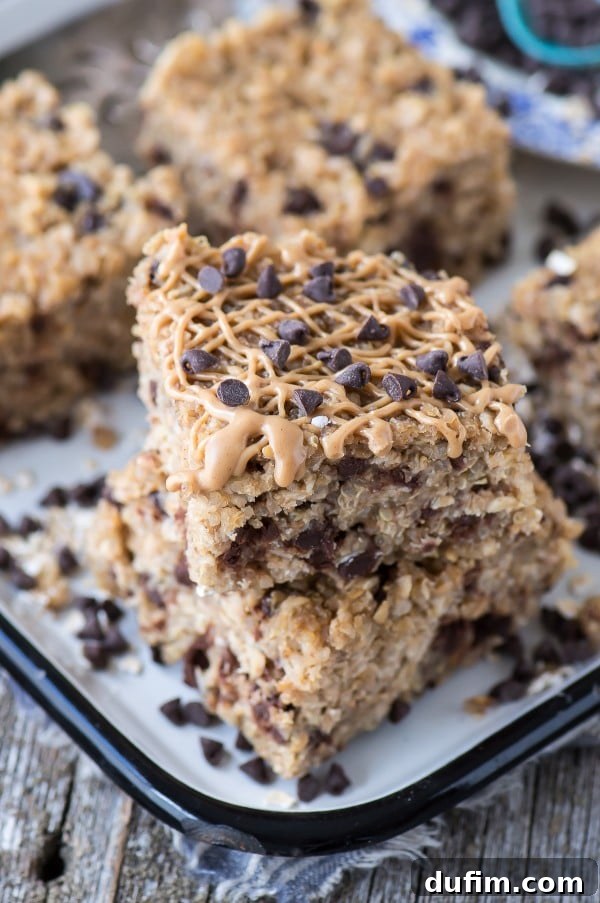 Moist & Delicious Homemade Quinoa Bars Healthy Peanut Butter Chocolate Chip Quinoa Granola Bars generously drizzled with creamy peanut butter, arranged invitingly on a baking dish.