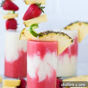 The best Miami Vice Mocktail! Half strawberry daiquiri half pina colada layered in one glass. A tropical non-alcoholic lava flow!