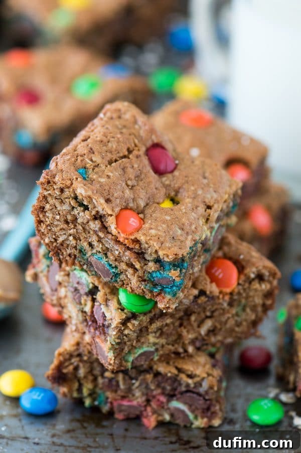 The full batch of healthier monster cookie bars showcased on a cutting board, ready for enjoyment.