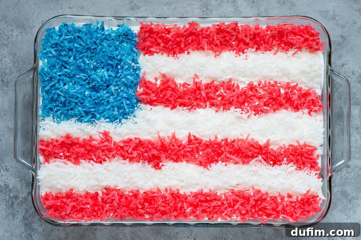 Stars and Stripes Celebration Cake 4 The American Flag Cake partially decorated, showing the blue corner and the start of the red and white coconut stripes.