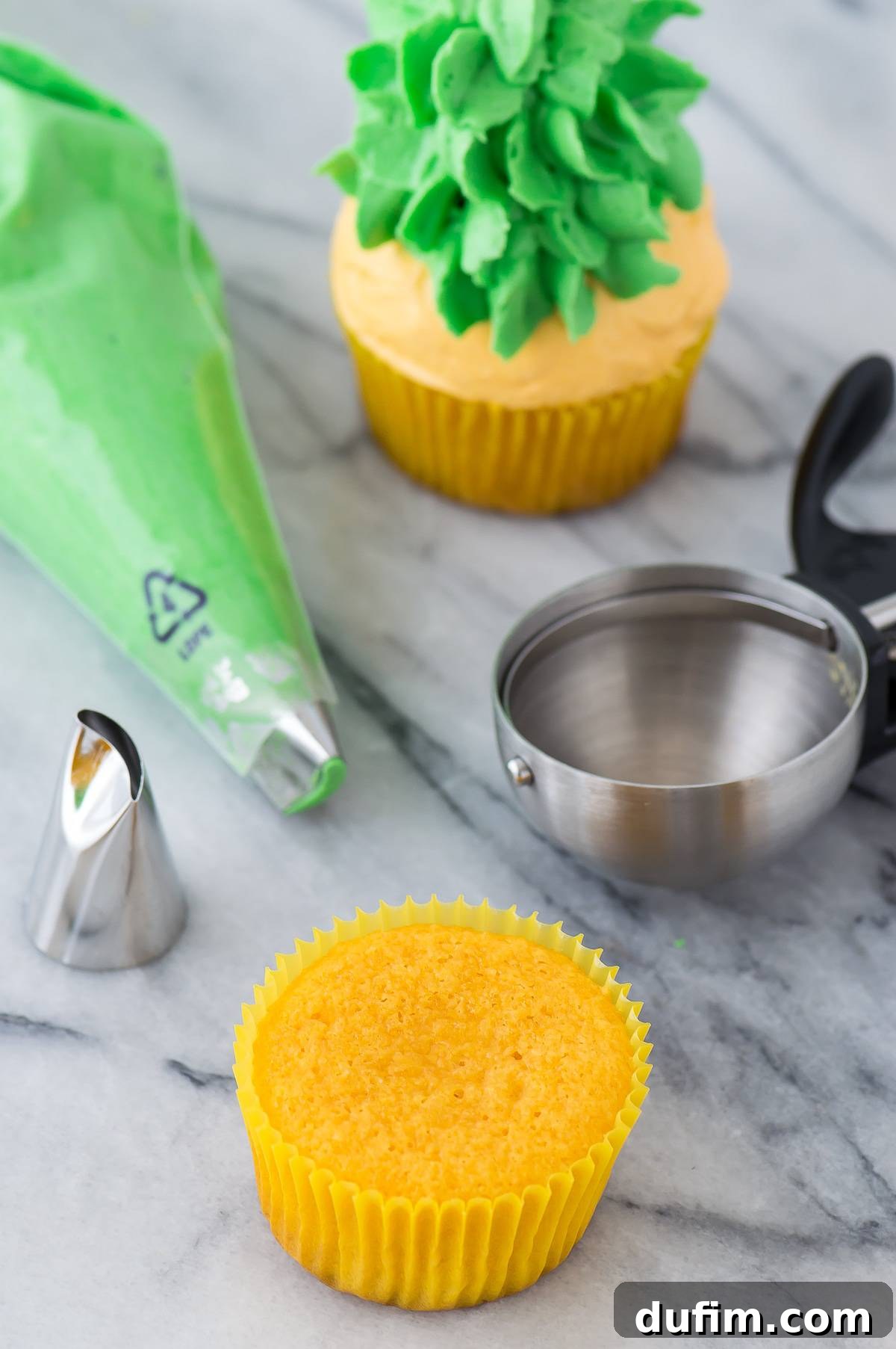 Several pineapple cupcakes arranged artfully on a white surface, highlighting their individual details and vibrant colors.
