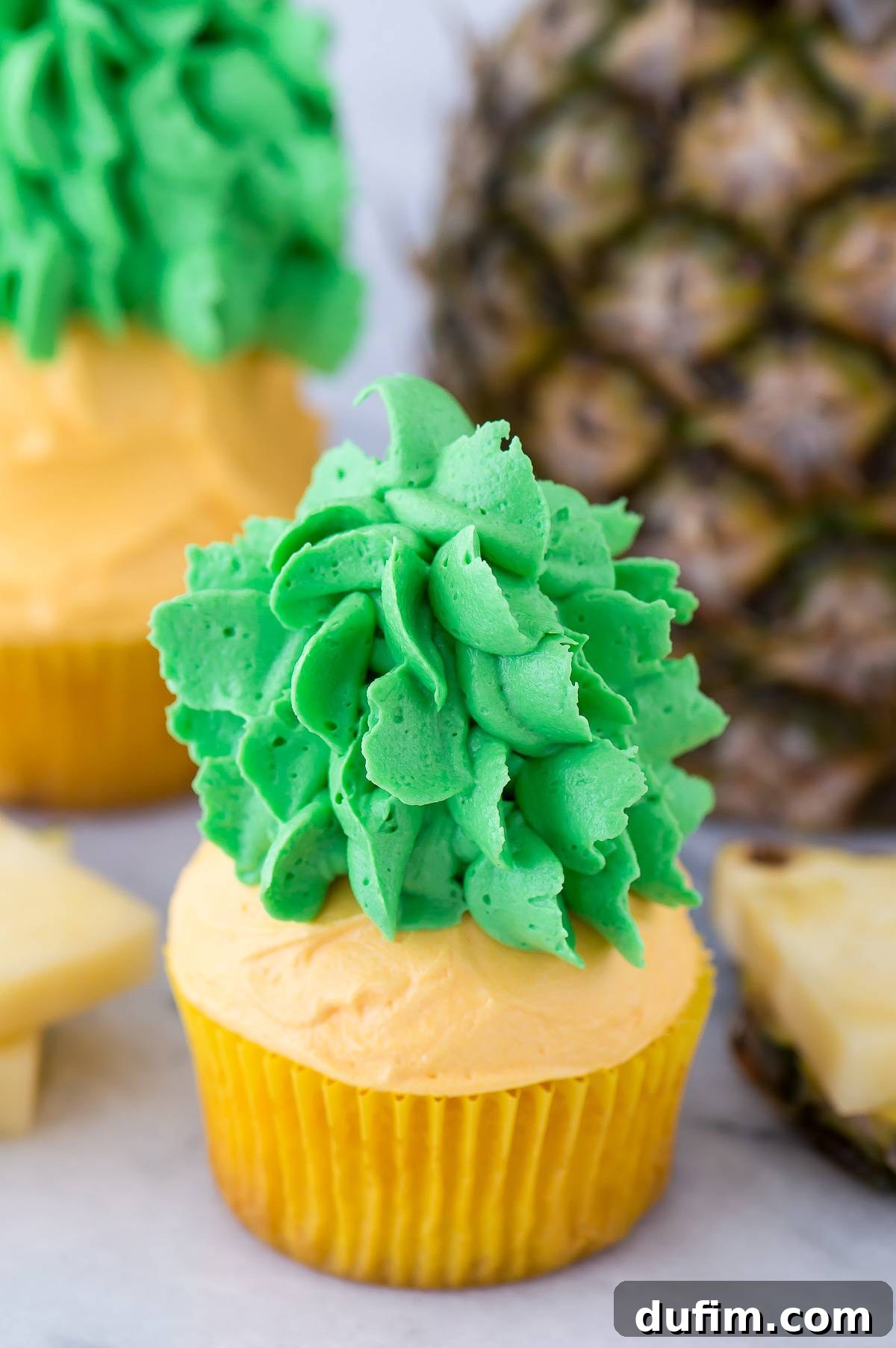 A beautifully arranged group of finished pineapple cupcakes, showcasing their vibrant colors and intricate designs.