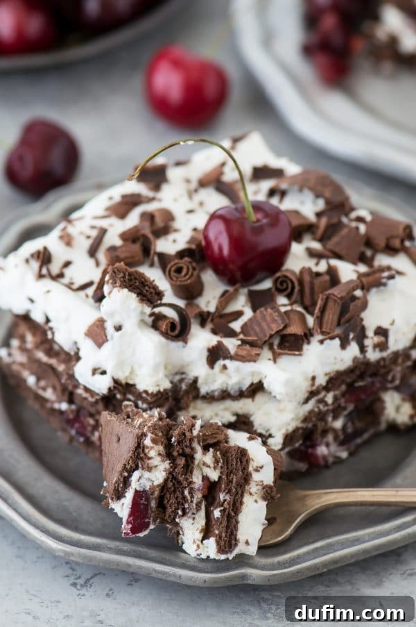 Black Forest Icebox Cake chilling in a pan, showcasing the vibrant red cherries and rich chocolate layers, ready for refrigeration.