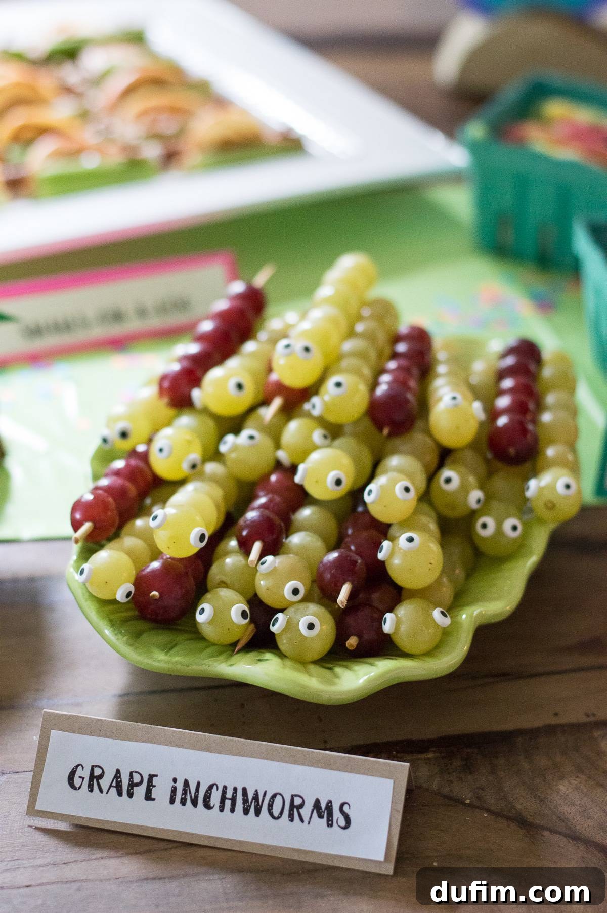 A Dream Fulfilled Adoption Party 13 Refreshing green grape inchworms on small wooden skewers, complete with adorable candy eyeballs, making for an easy, healthy, and visually appealing party snack.