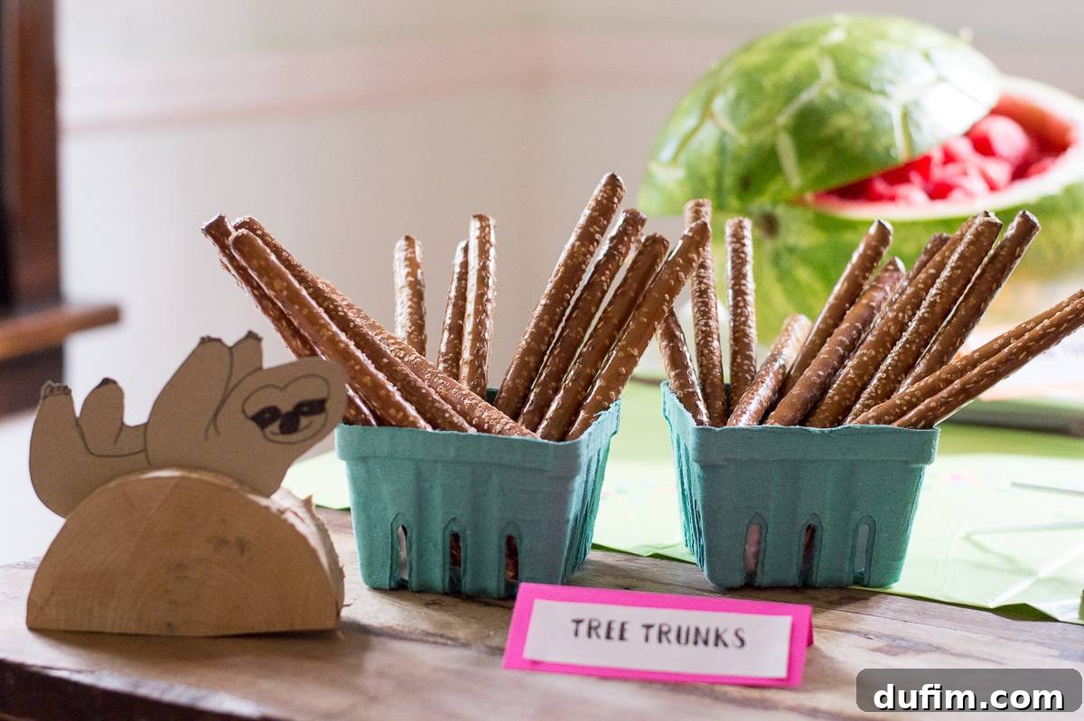 A Dream Fulfilled Adoption Party 10 An inviting assortment of 'Worth the Wait' party food, featuring various themed treats including pretzel rods, fresh fruit, and other creative snacks for guests.