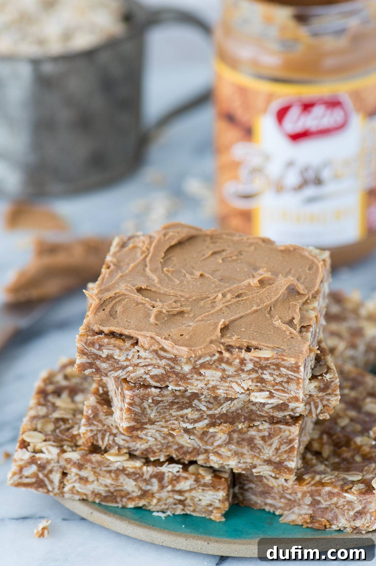 Biscoff Cookie Butter Oat Bars 6 A stack of delicious Biscoff oat bars on a teal plate, ready to be enjoyed.
