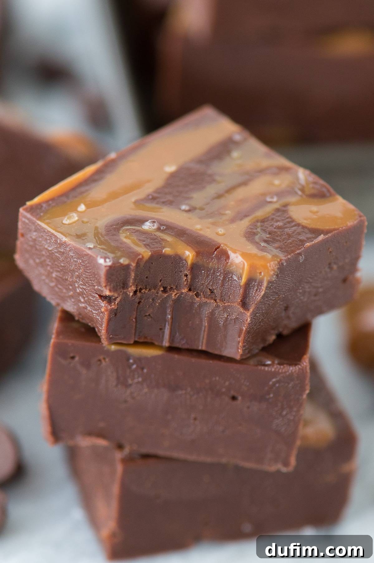 A delicious piece of Salted Caramel Mocha Fudge with dulce de leche on a white surface