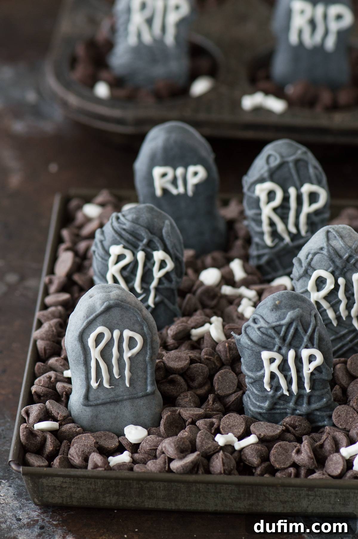 Eerie Nutter Butter Graveyard Treats 2 Delicious Nutter Butter Tombstones arranged in a chocolate chip graveyard, perfect for Halloween parties and treats.