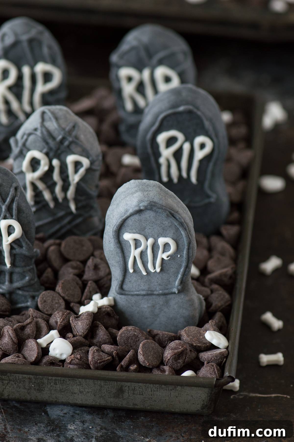 Eerie Nutter Butter Graveyard Treats 4 Collection of Nutter Butter Tombstones with different shades of gray and decorative etchings, ready for display.