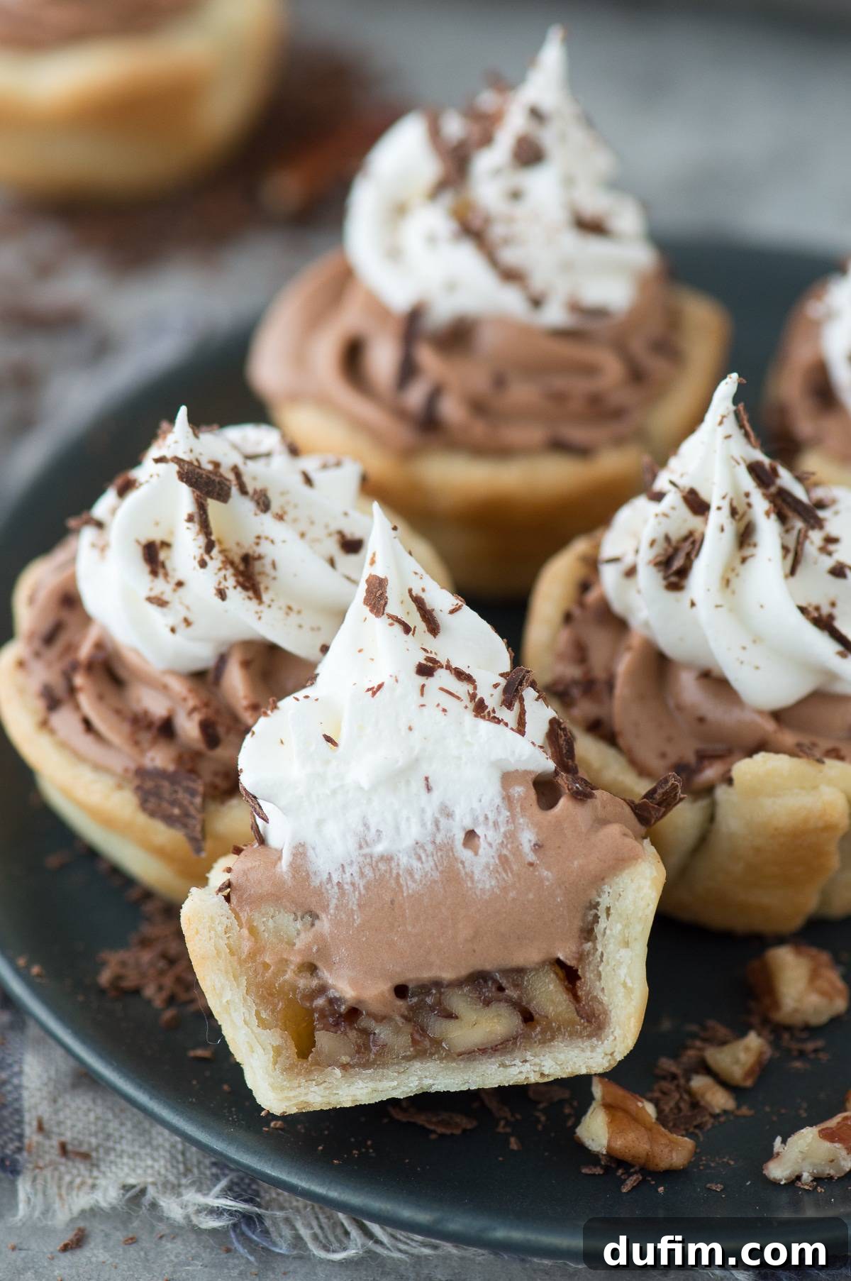 Mini chocolate silk pecan pie bites are the perfect dessert mash-up for Thanksgiving! These mini pies have a pecan pie layer and a chocolate silk layer!