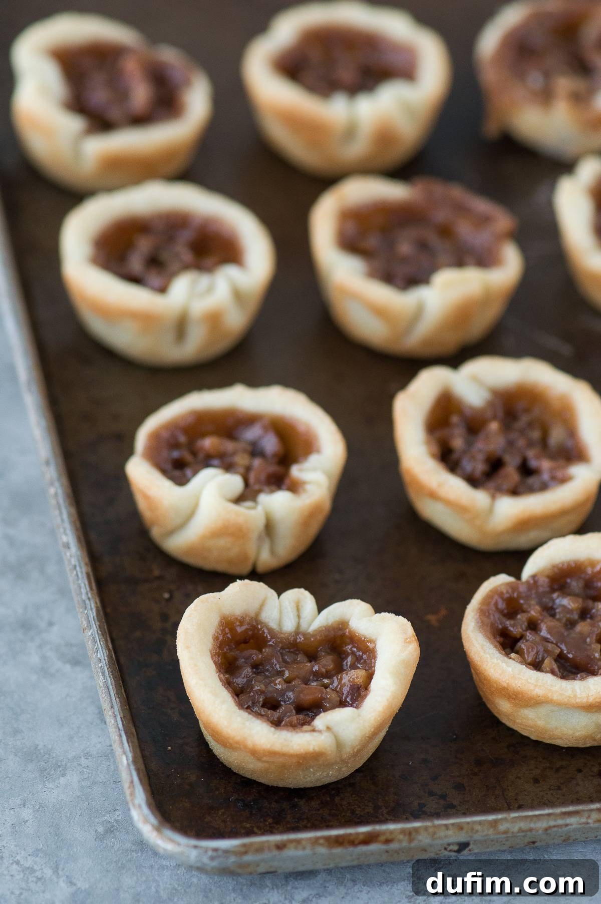 Mini chocolate silk pecan pie bites are the perfect dessert mash-up for Thanksgiving! These mini pies have a pecan pie layer and a chocolate silk layer!