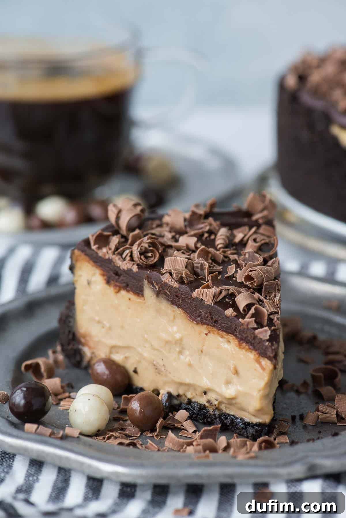 A pristine slice of coffee cheesecake elegantly presented on a metal plate, ready to be enjoyed.