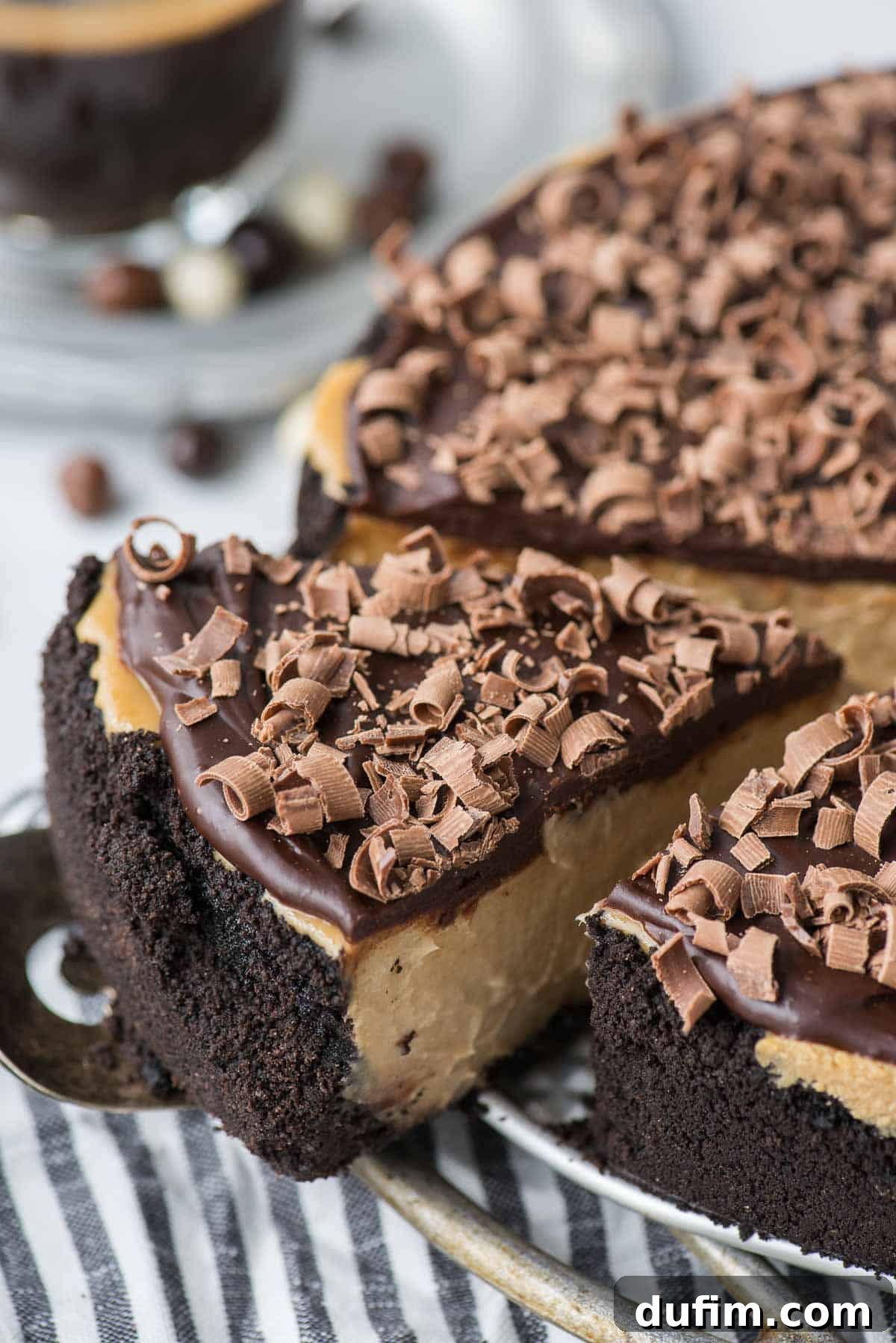 Another mouth-watering slice of coffee cheesecake on a metal serving spatula, highlighting its creamy texture.
