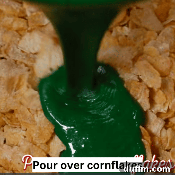 Golden No-Bake Wonders 7 Melted green marshmallow mixture being poured gracefully over a bowl filled with crunchy cornflakes, a crucial step for making delicious wreaths.
