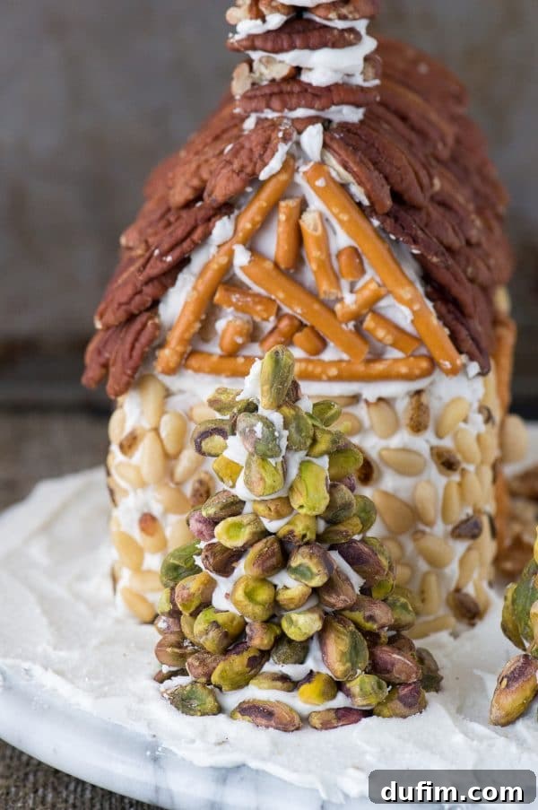 Festive Gingerbread Folly 11 Gingerbread house with snowy landscape, fire pit, and rustic nut decorations.