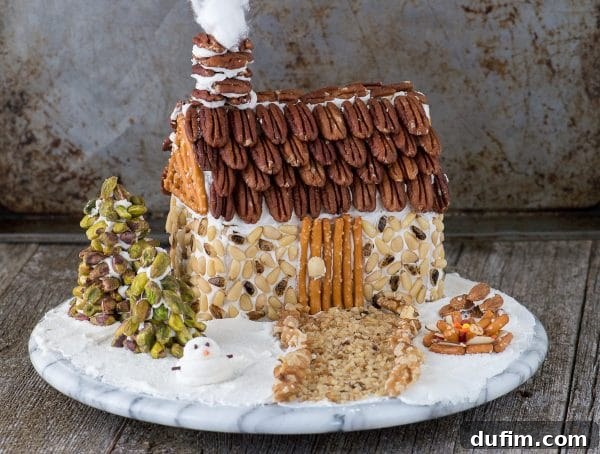 Festive Gingerbread Folly 3 Close-up of a gingerbread house assembly, showing graham crackers forming the walls.