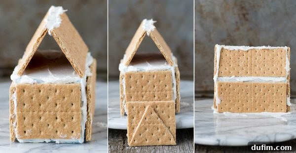Festive Gingerbread Folly 5 Gingerbread house structure with graham crackers and icing, drying on a flat surface.