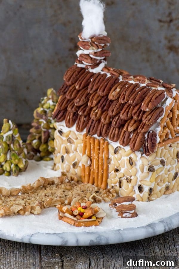 Festive Gingerbread Folly 6 Rustic gingerbread house detailed with pine nut siding and intricate pecan roof shingles.