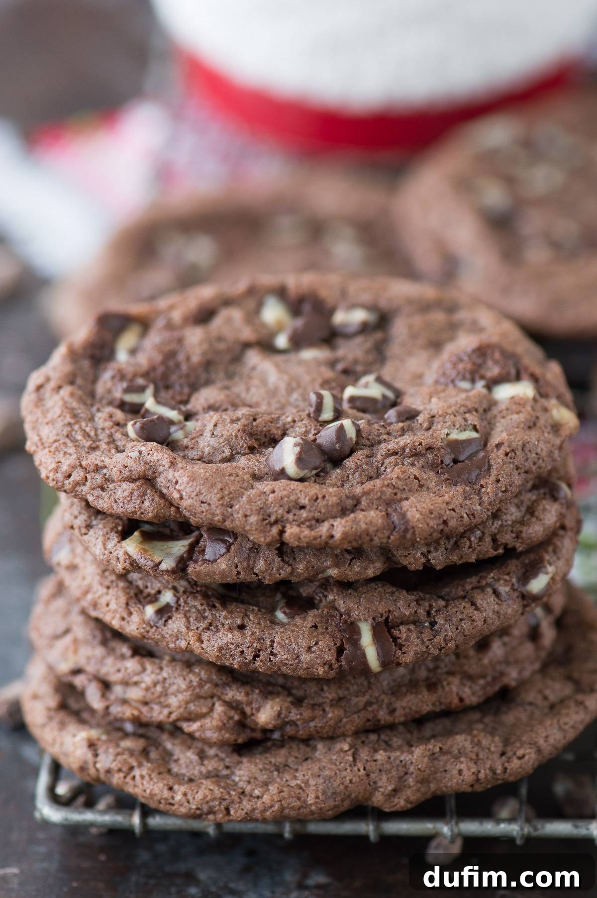chocolate peppermint cookies stacked on top of each other on dark background
