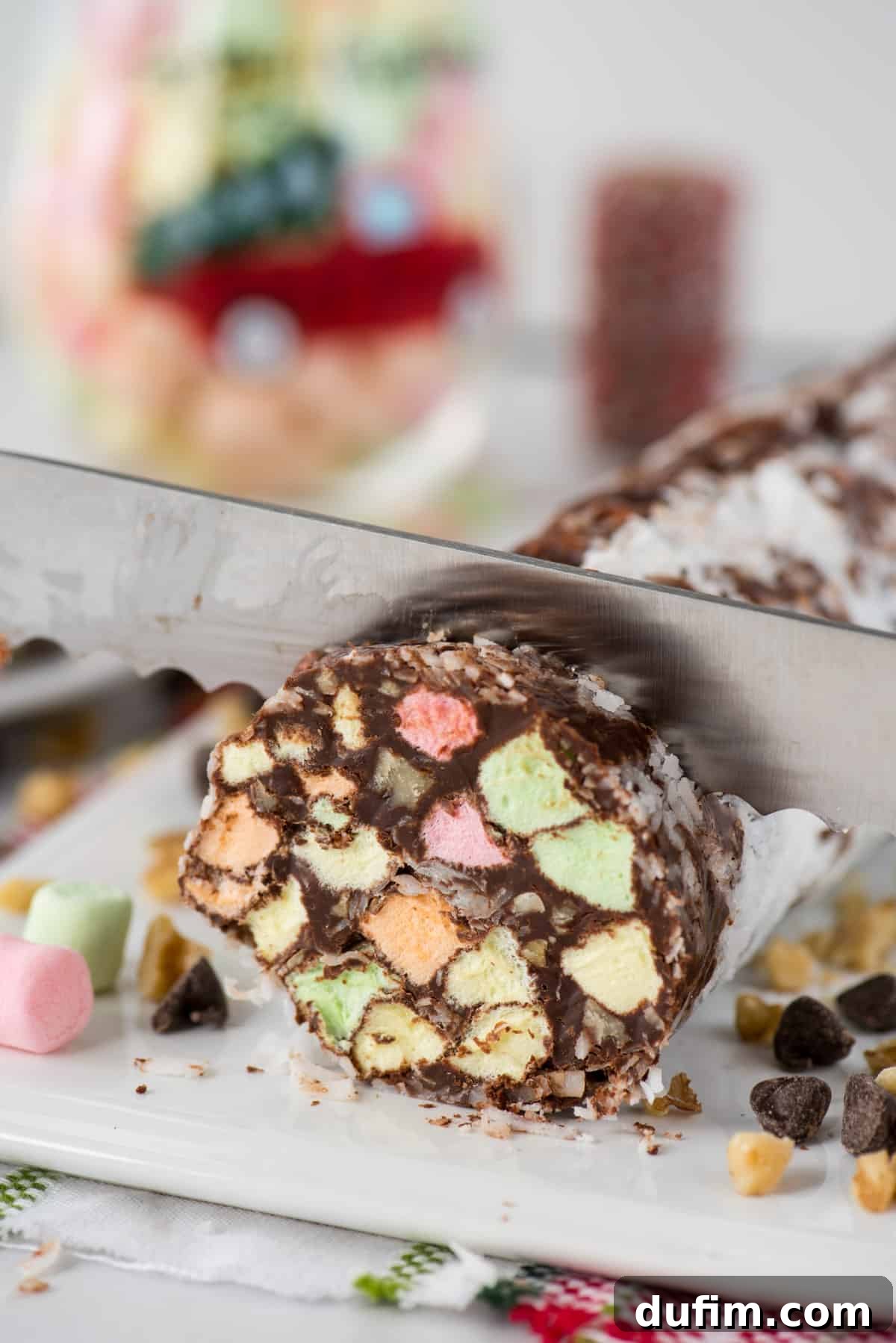 no bake christmas church window cookies being sliced with serrated knife on white platter